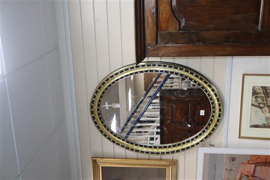 A pair of Irish style oval mirrors with glass-mounted gilt and ebonised frames H.105cm